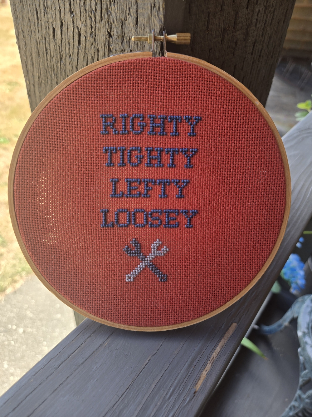 Cross-Stitch Hoop: 'Righty Tighty Lefty Loosey' on Red Aida